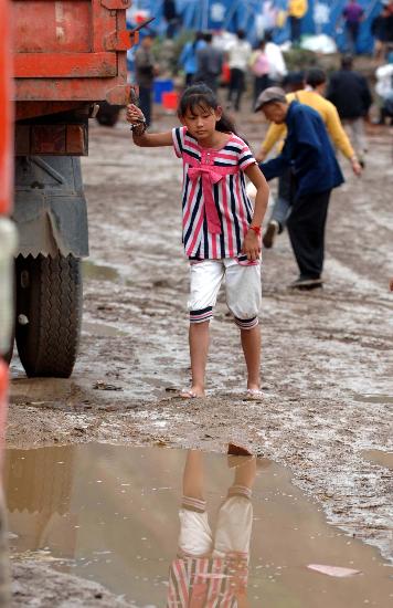 图文:一名孩子在泥泞的道路上行走