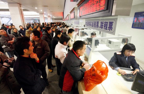 图文:旅客正在上海南站购票大厅购买车票