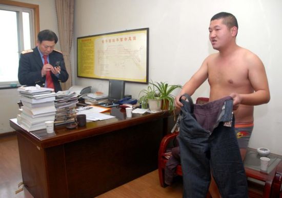 陈伟伟到副站长室“裸奔”讨说法，但副站长显然顾不上他，正忙着摆弄手机。(资料图片)