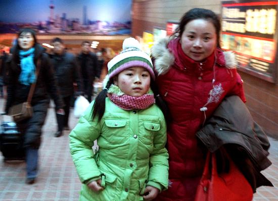 图文:一对母女在上海火车站出站