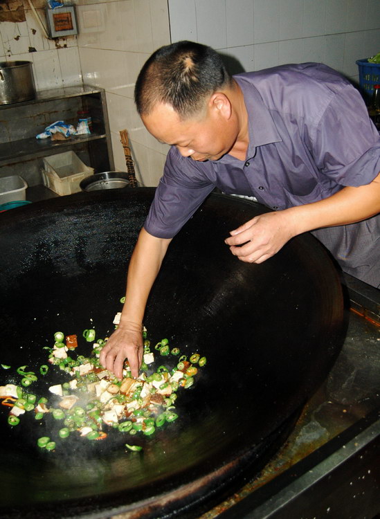 图文厨师表演用手在热锅里炒菜绝活