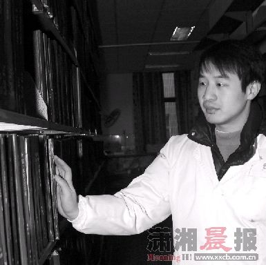 昨日，郑长贵在图书馆整理图书。图/通讯员王建新