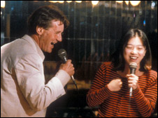 Two people singing karaoke