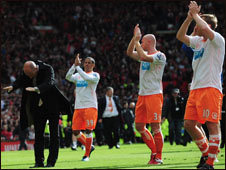 Blackpool manager Ian Holloway (left) bows to supporters while his players applaud