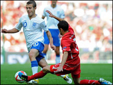 Jack Wilshere of England (left) is tackled by Tranquillo Barnetta of Switzerland
