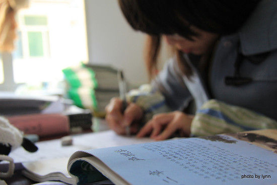 志愿者刘燕为了回答好同学的问题，计时间，正在做期中考试物理试题。