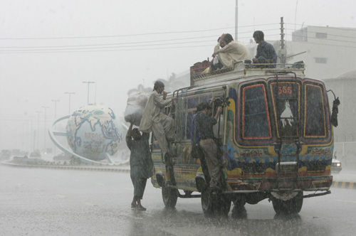 Heavy rain didn't deter these men in Karachi, Pakistan, from riding on the outside of a bus. Ҳֹ˰ͻ˹̹ʰʿƤľġ