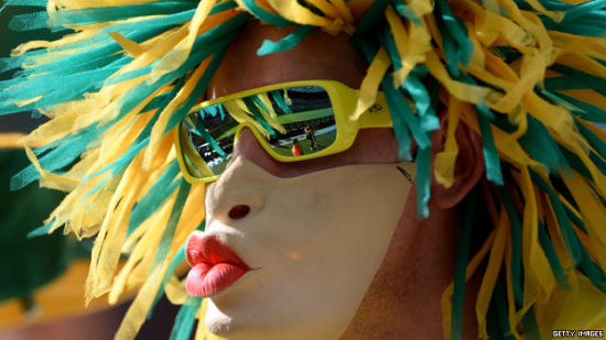 A Brazilian football fan wearing a mask