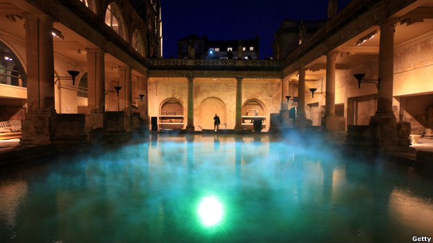 Coloured lights illuminate steam rising at the Roman Baths in the city of Bath, England.