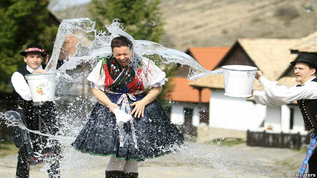 Men throw water onto a woman as part of a festival in Hungary.