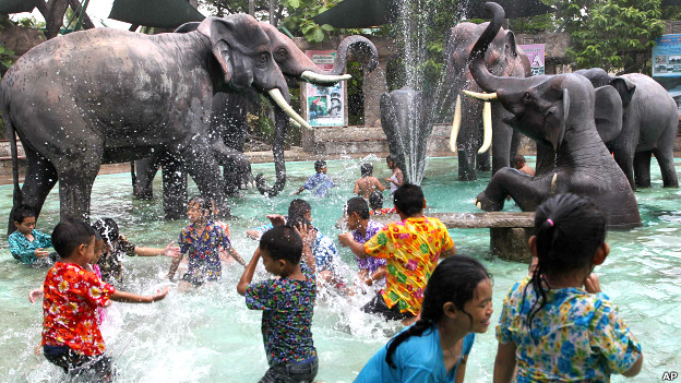 Thai children play in a pool decorated with elephant sculptures 