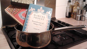 A saucepan with books in it on the stove
