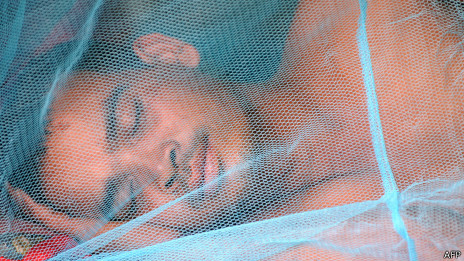 Man sleeping under a mosquito net