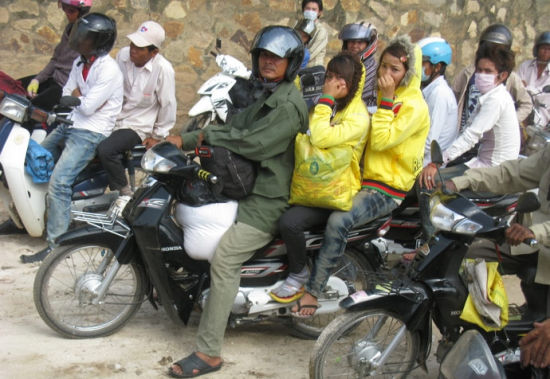 A motorcycle carrying something and manned