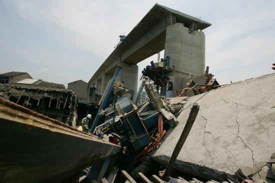 图文倒塌下来的移动模架砸中路边民房